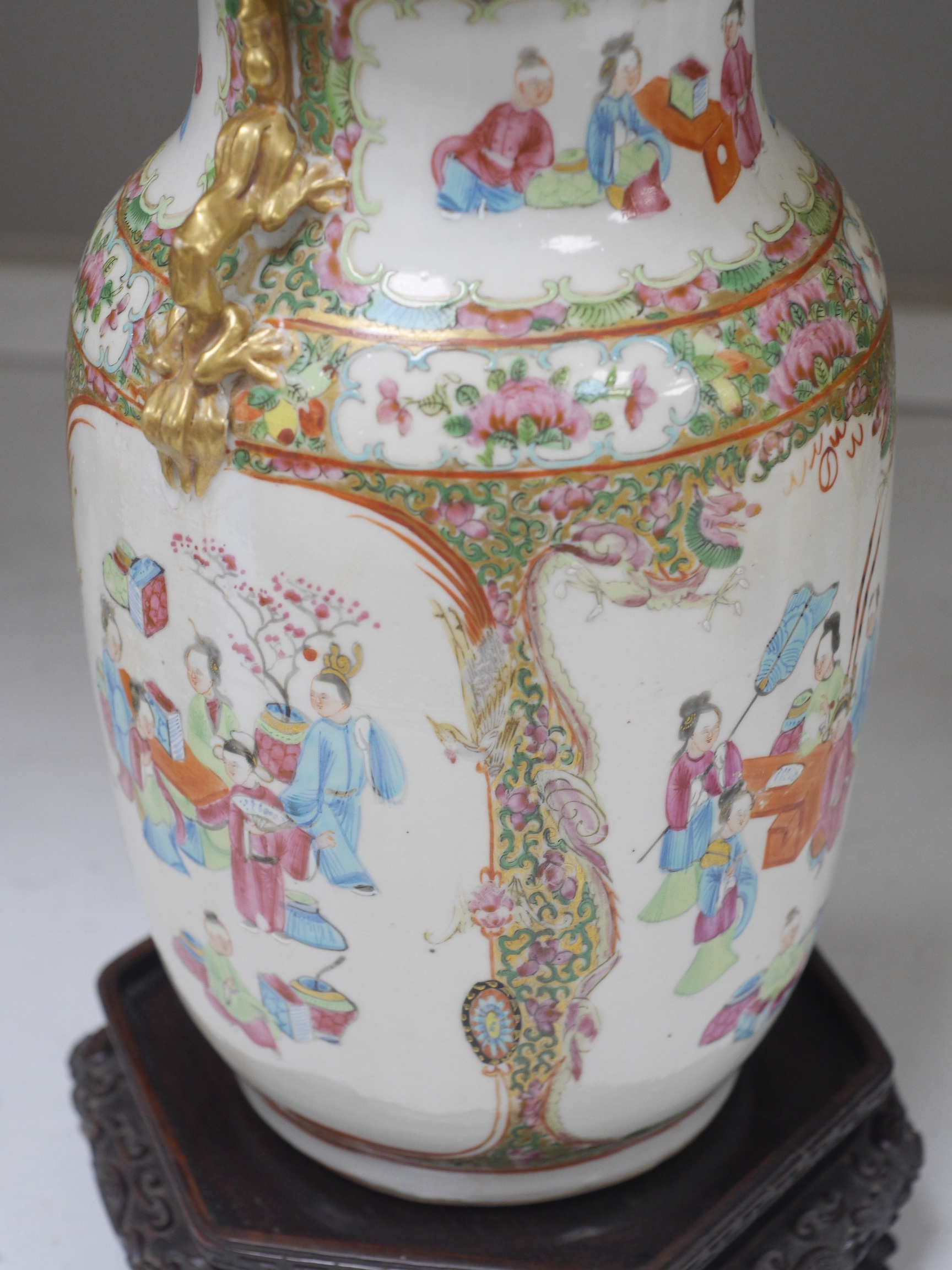 A Chinese famille rose vase and cover, late 19th century, together with a good carved hongmu ‘bats and shou’ stand, vase 36cm. Condition - crack to rim